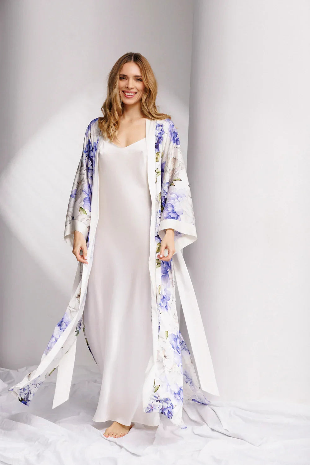 Woman wearing a white silk nightdress (sold separately) with a floral kimono over it.