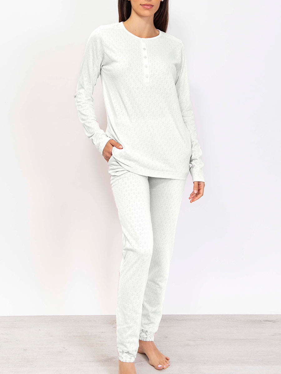 This premium pointelle cotton pajama set is crafted with a soft, subtly-textured fabric. Its long-sleeved top and trousers feature an elegant color palette that strikes a balance between comfort and style. 