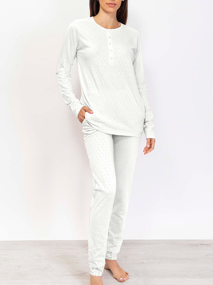 This premium pointelle cotton pajama set is crafted with a soft, subtly-textured fabric. Its long-sleeved top and trousers feature an elegant color palette that strikes a balance between comfort and style. 