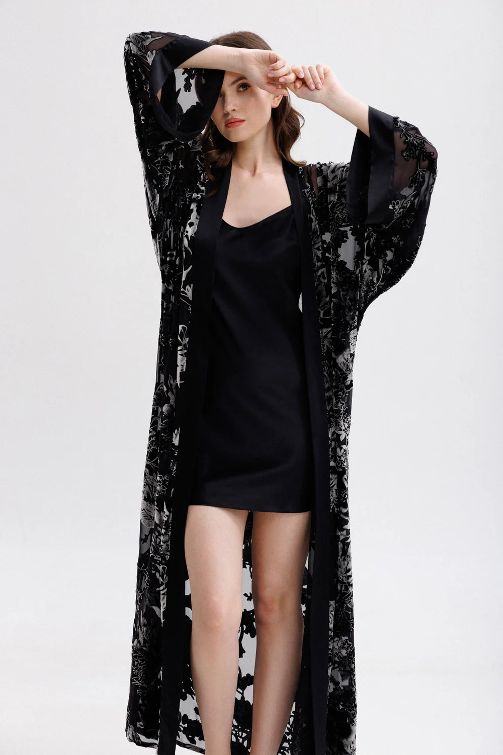 Woman wearing a black silk short slip dress with spaghetti straps showing the full figure with matching silk-velvet kimono(sold separately)