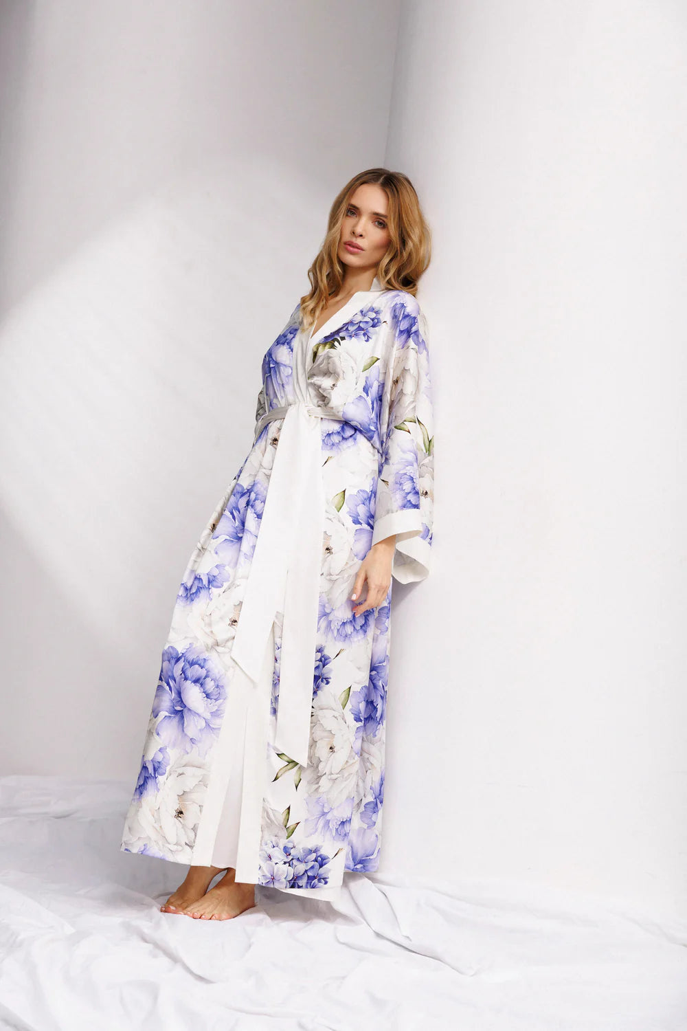 Woman wearing a long floral silk kimono with wide belt-front picture